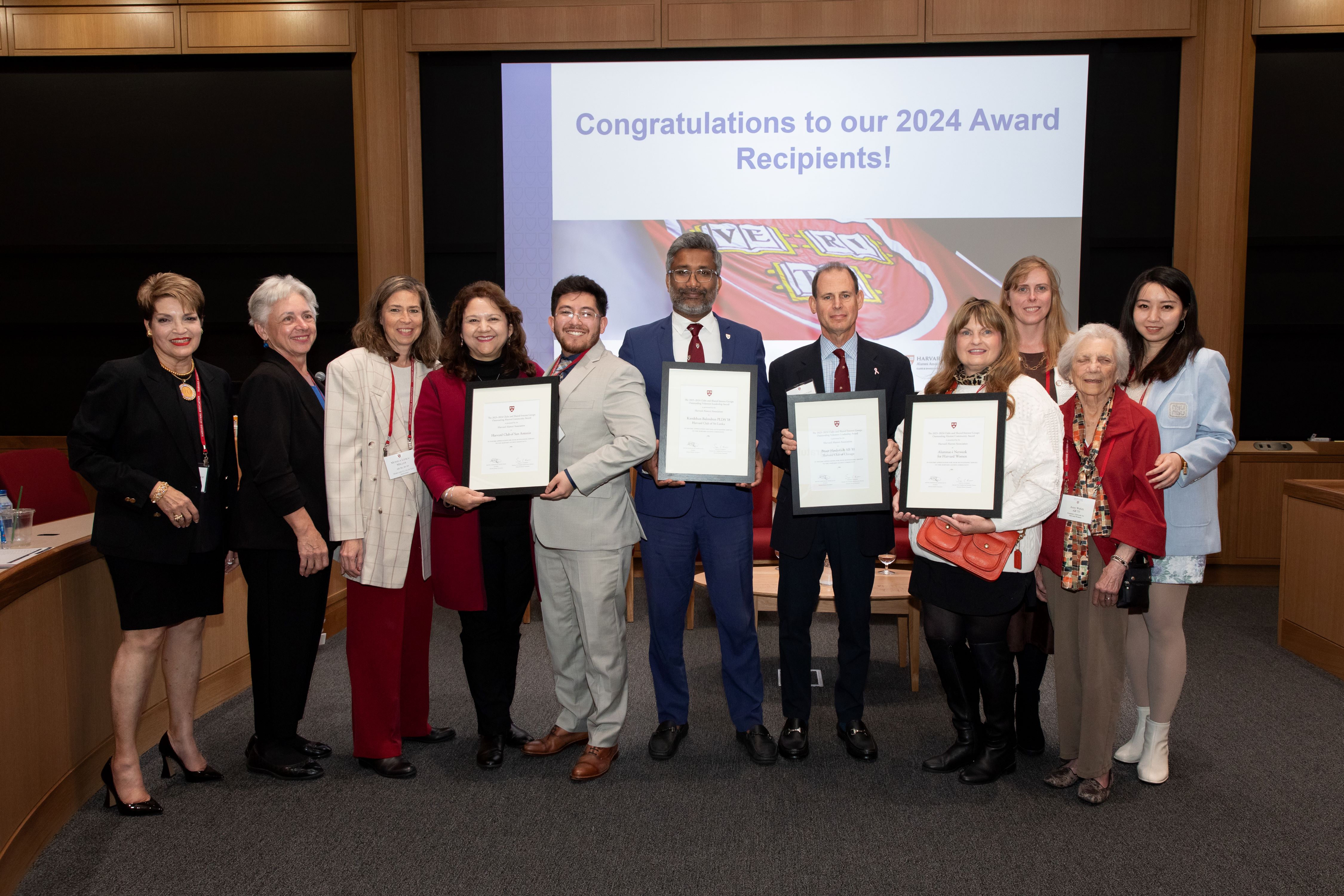 Six Club & SIG volunteers standing together holding their awards